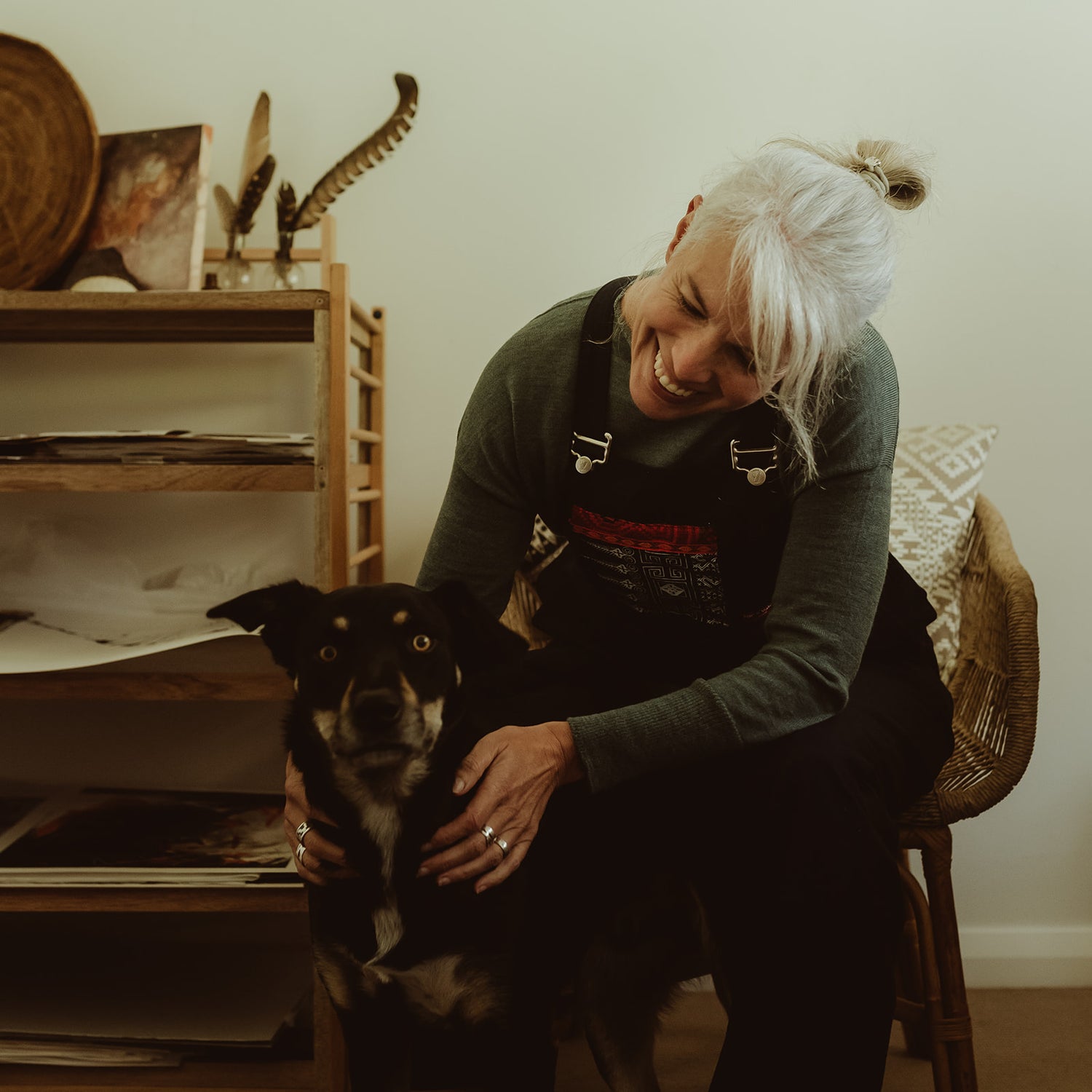 Contemporary abstract, woman artist, Freya Job, in her home studio with her tricolour kelpie dog.
